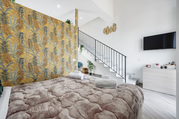 Dormitorio con balcón con vista al mar, con Smart TV, aire acondicionado, bomba de calor, wifi, armario, sábanas, almohadas, toallas, cortinas opacas y escalera privada que conduce a la terraza privada.