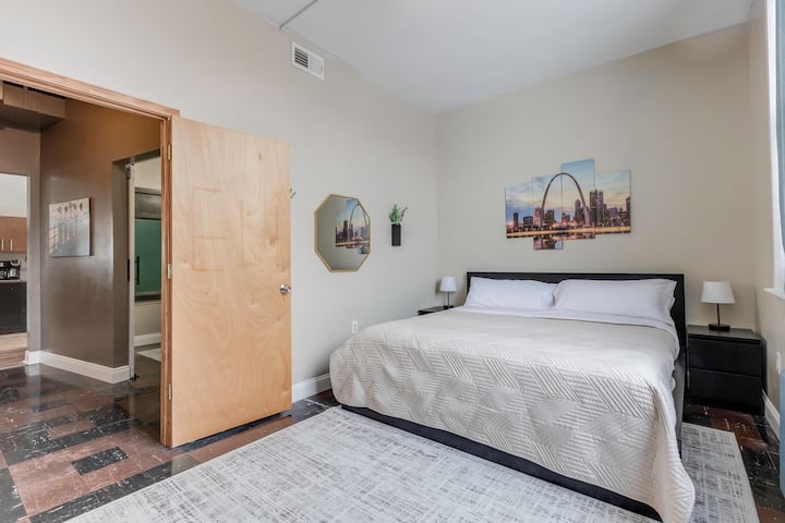 King-size bed with bedside tables and lamps with built-in plug-ins for all of your devices on both sides of the bed.