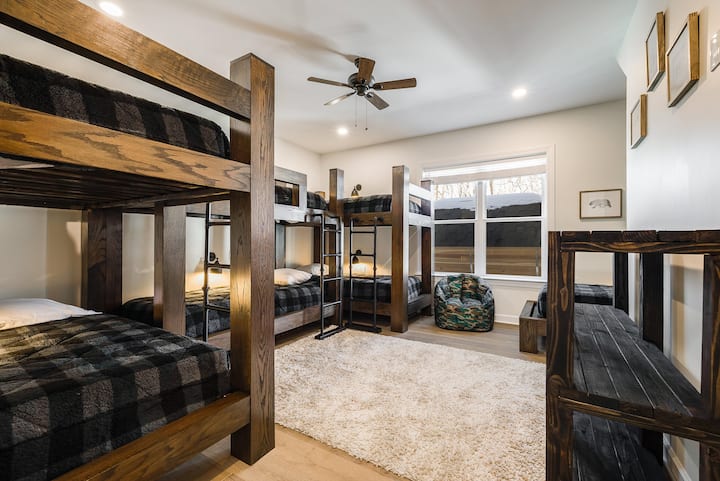 This spacious bunk room is perfect for kids, friends, or group stays, with plenty of room to spread out and relax.