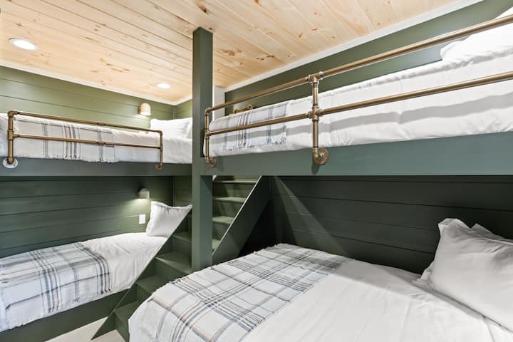 The bunkroom has 3 twin beds and 1 queen. Each bed has its own outlet and wall sconce. 