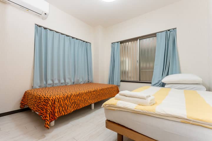 There are two single beds and a closet; extra bedding is located inside the closet.