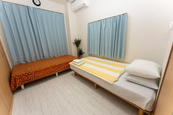There are two single beds and a closet; extra bedding is located inside the closet.