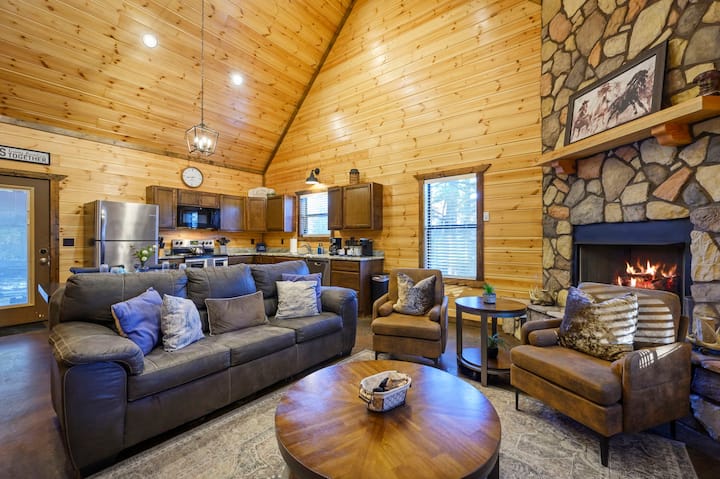 Esta acogedora cabaña de madera cuenta con todo lo necesario: chimenea de piedra, cocina completa y cómodos asientos para toda la familia.