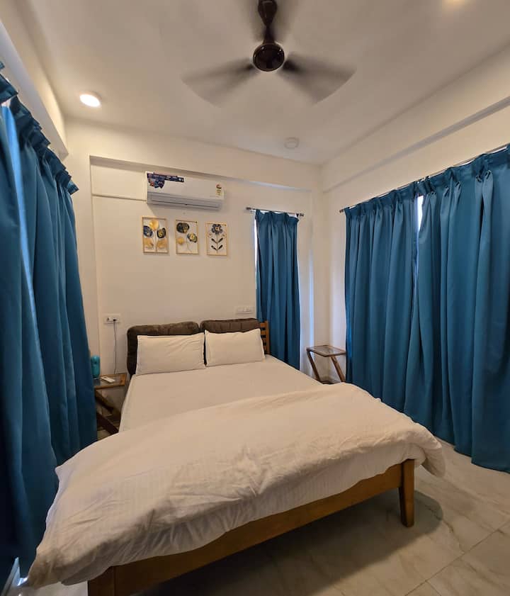 “A bright and comfortable bedroom featuring a cozy bed, large windows with elegant curtains, and a calm, airy ambiance. The clean and inviting space offers a peaceful setting ideal for relaxation and restful nights.” ️✨