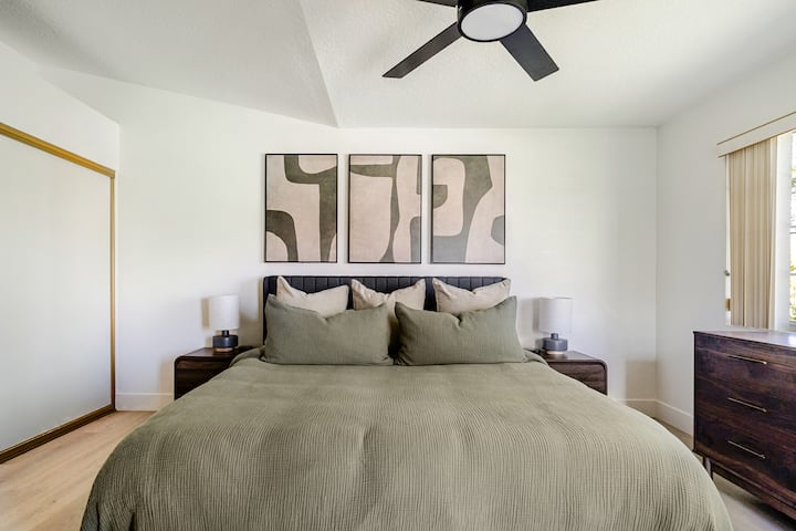 Retreat to a serene primary bedroom featuring a plush king-size bed, calming earth tones, and modern minimalist decor.
