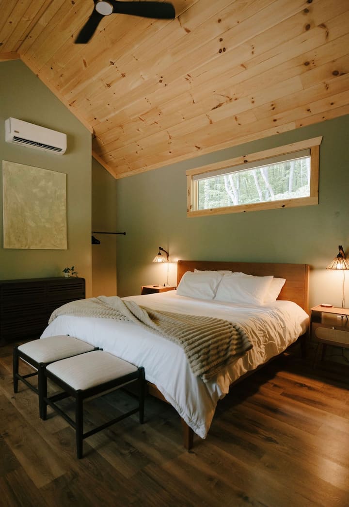 Spacious king suite with crisp white linens, blackout shades, air purifer and a ceiling fan. An attached bathroom with privacy curtain (no door), full size dresser and clothing and luggage storage.
