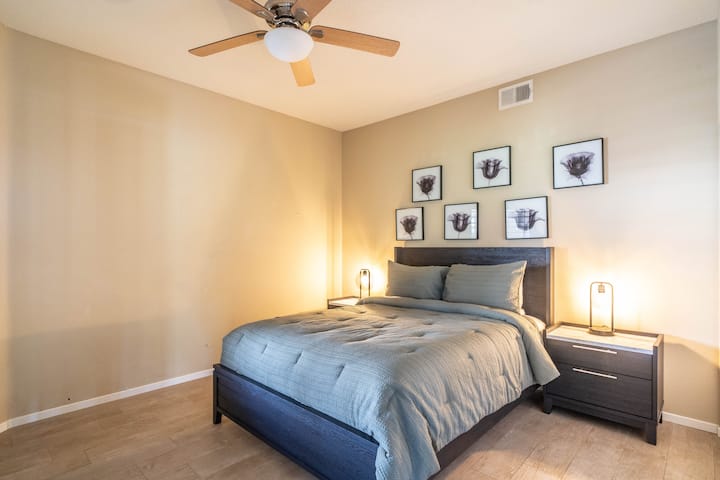 Guest bedroom includes a queen size bed, spacious nightstands, and bonus dedicated workspace.