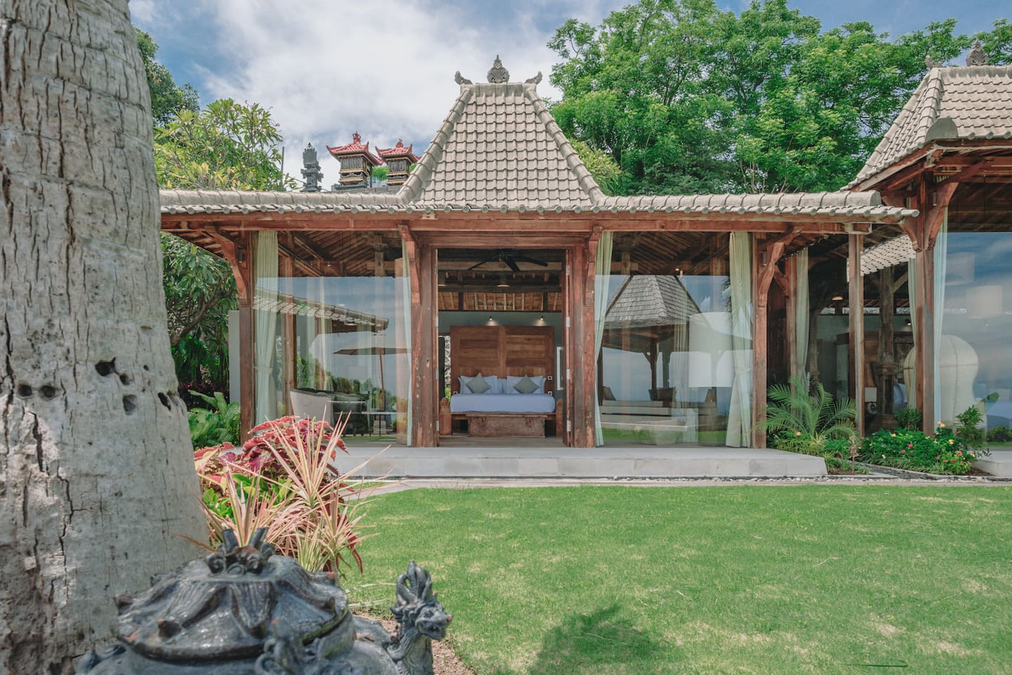 Garden joglo suite with glass walls opening onto the lawn
