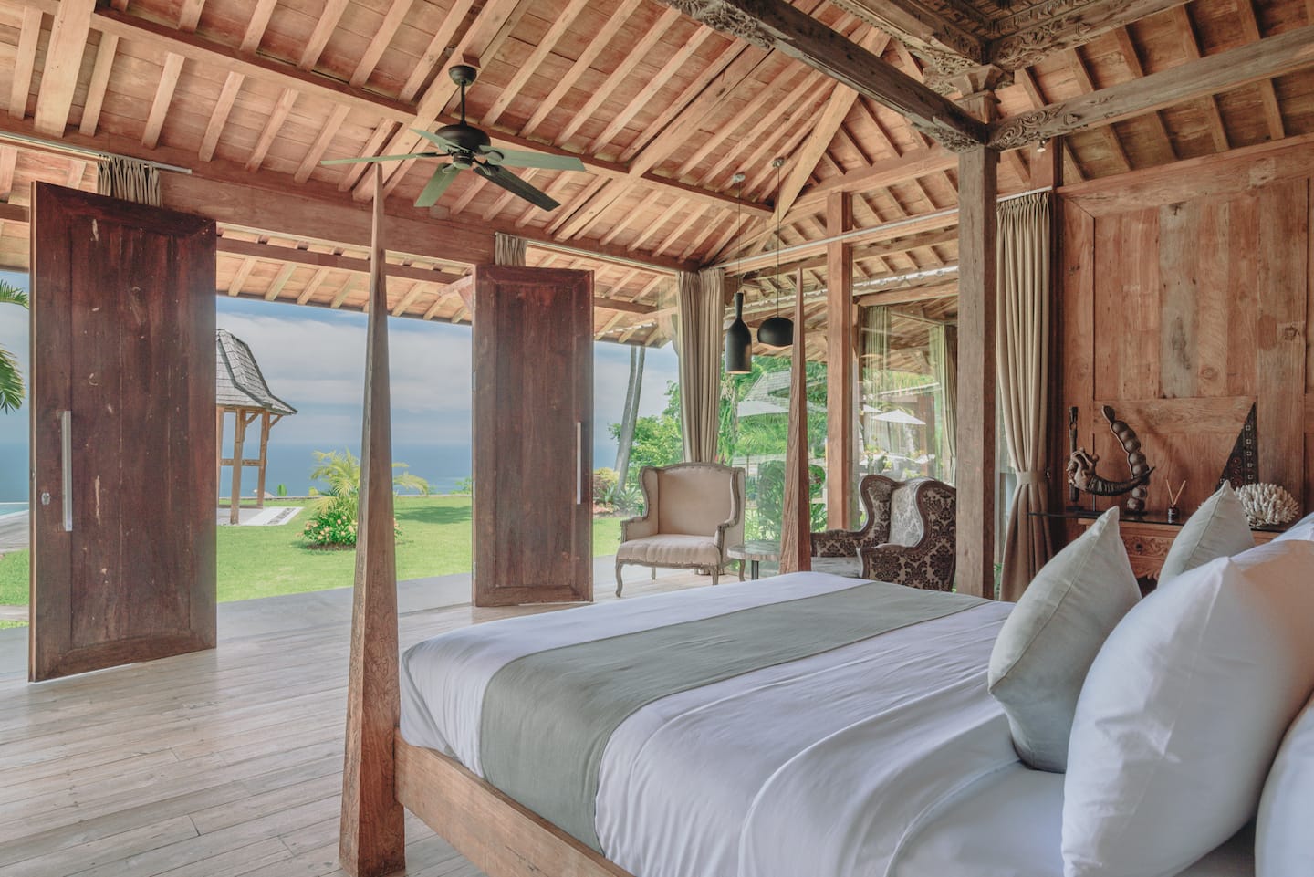 Four-poster king bed in a wooden joglo suite
