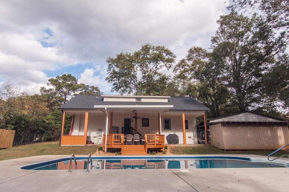 Back of the house with the pool and covered patio