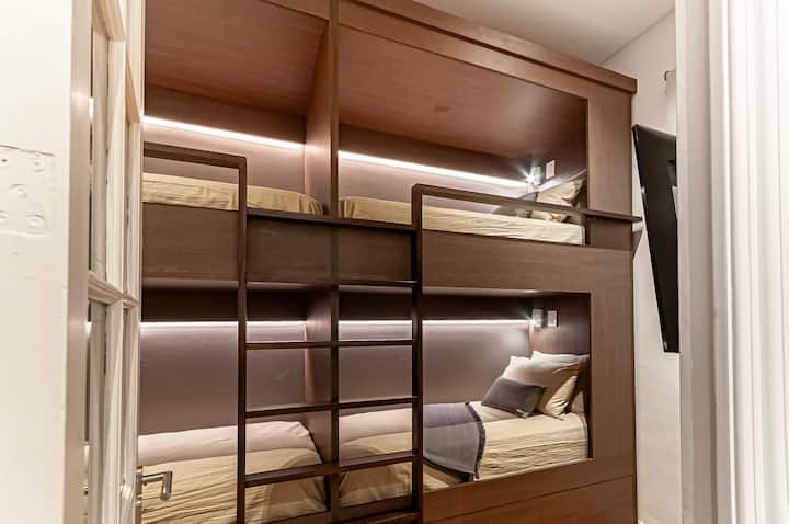 - 2  Custom capsule-style bunk beds (4 luxury twin mattresses that are 1.90 meters X 0.80 meters, designed for exceptional comfort and ideal for adults or kids
- Each pod w/ its own reading light and power outlet  
- 50" Samsung 4K smart TV
-AC/Heat