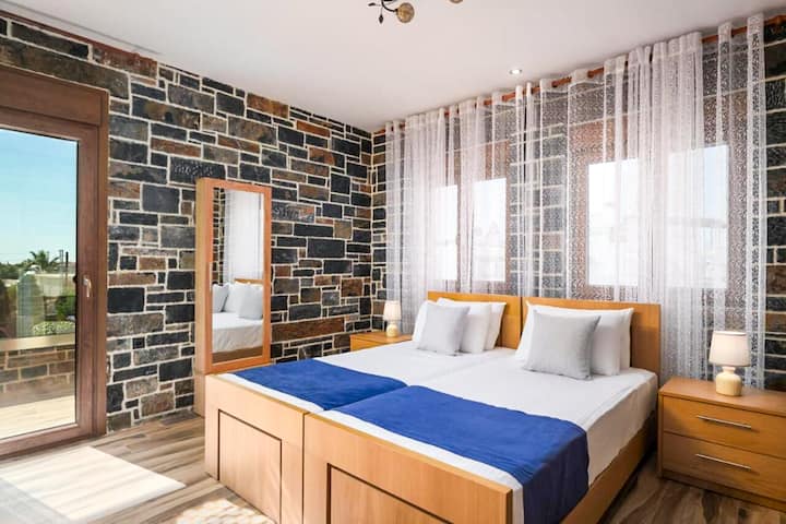 Upper Level - Bedroom 2 with two single beds and balcony access