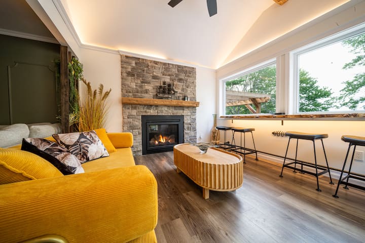 Bright sunroom/living room with one-touch propane fireplace.