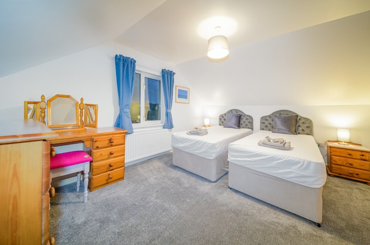 Our twin room upstairs with wardrobe, chest of drawers and dressing table could be converted to a king-size bed. Just let us know when you're booking.