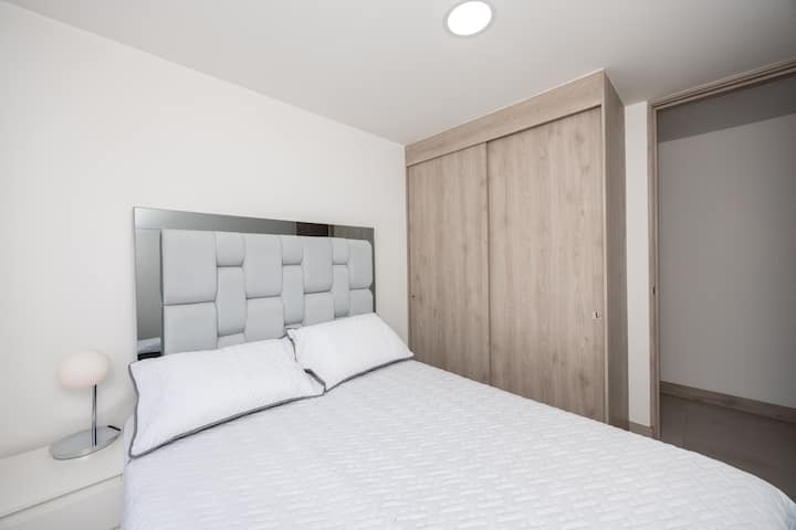 room with closet, clothes hangers and extra clothes for your comfort.