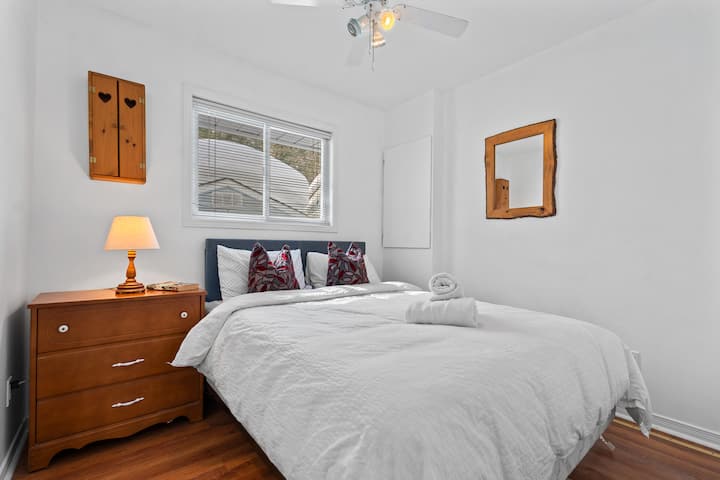 Bright and comfortable bedroom with soft linens, natural light, and a peaceful atmosphere for a restful stay.
