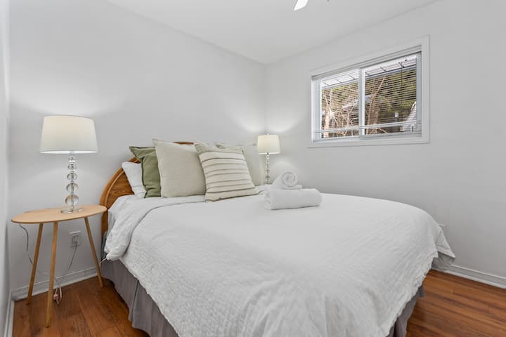 Bright and cozy bedroom featuring a comfortable bed, soft linens, and natural light from the window, the perfect place to relax after a day of exploring.