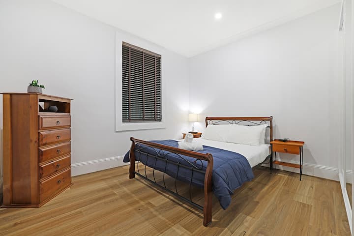 Generous second bedroom with simple layout and practical storage.