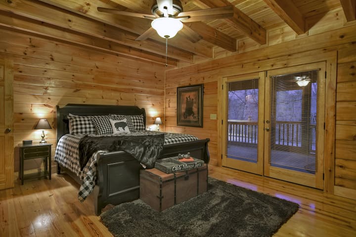 King bed in bedroom on main floor goes out to screened porch