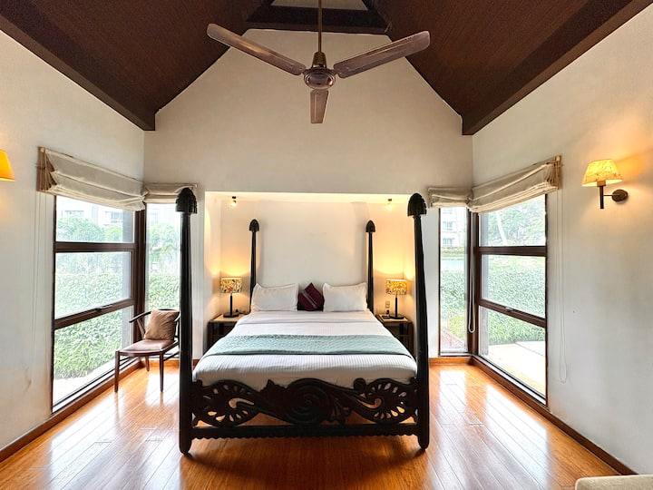 A luxurious sunlit bedroom featuring an ultra-comfortable bed, premium linens, and a smart TV for ul