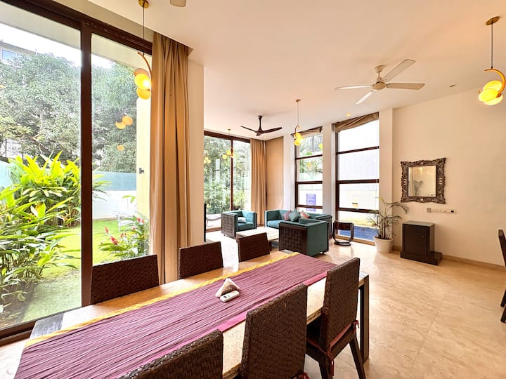 Spacious dining area bathed in natural sunlight, ideal for comfortable indoor dining.