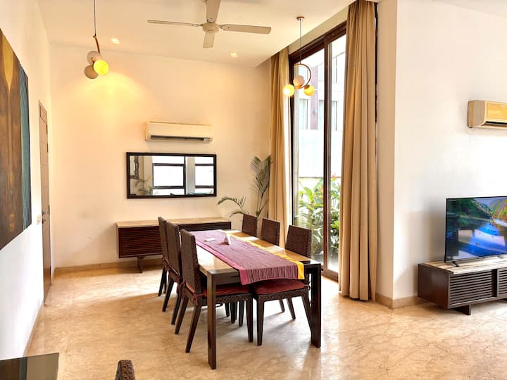 Bright and airy dining space filled with natural light and ample room for family dining.