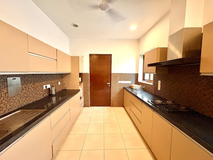 Spacious, fully functional kitchen with modern appliances and a washing machine for complete home-st