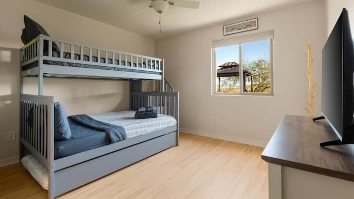 Comfortable bunk room with a twin-over-full layout and additional trundle, sleeping up to 4 guests—ideal for families or groups traveling together.