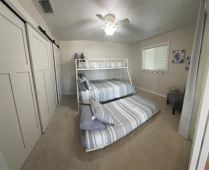 Kid's bedroom features a twin over full bunk bed and pull out twin trundle bed.