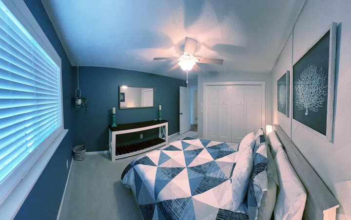 Bedroom 2 features a queen bed, closet, 2 nightstands and a large console table.