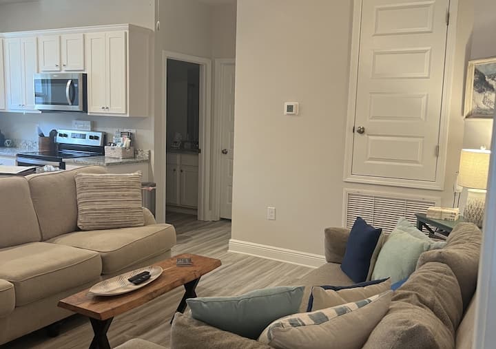 On suite Living room featuring 2 couches and 75" TV