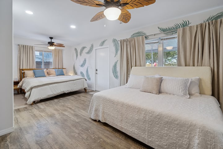Suite principal con camas king y queen, baño principal privado con ducha de efecto lluvia, cortinas opacas, ventiladores de techo, mesitas de noche con puertos USB, tocador alto, televisión inteligente y armario con puertas corredizas con espejo de cuerpo entero. Capacidad para 4 personas.