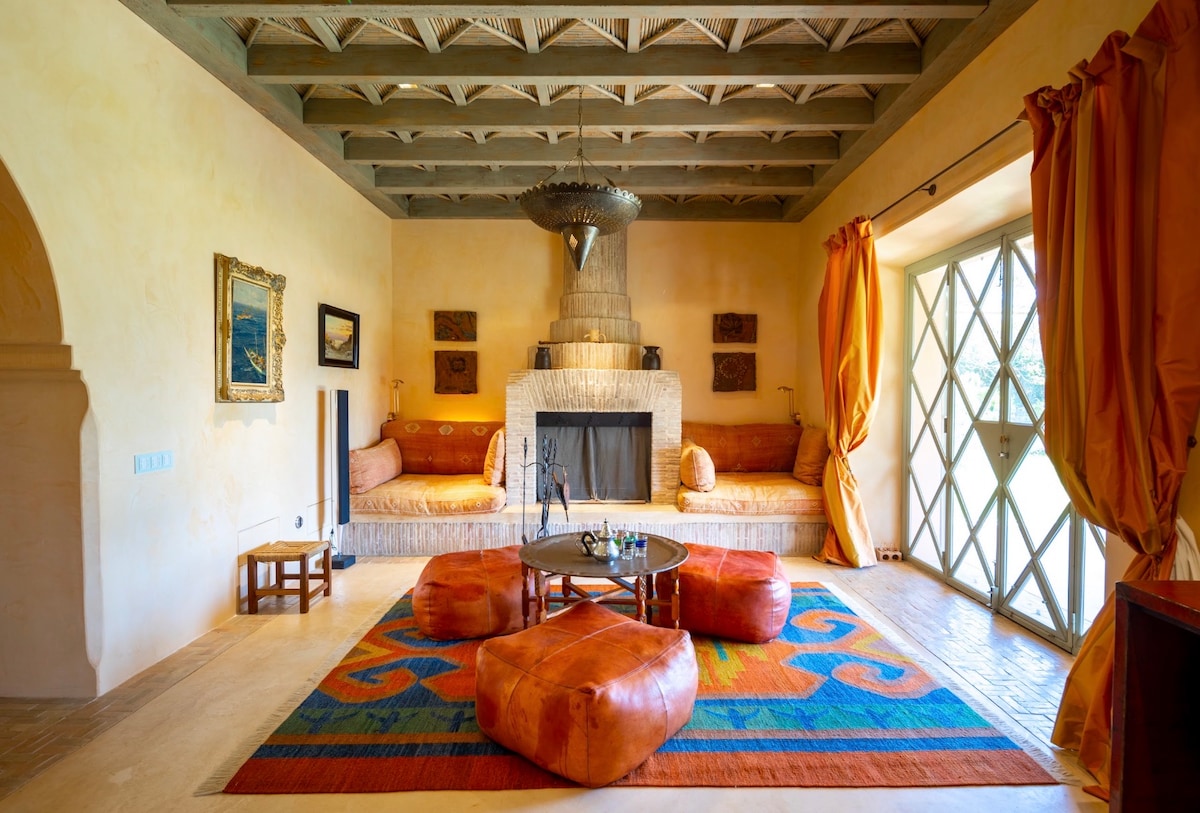 Living room of The Arabic House, with a fireplace and built-in seating