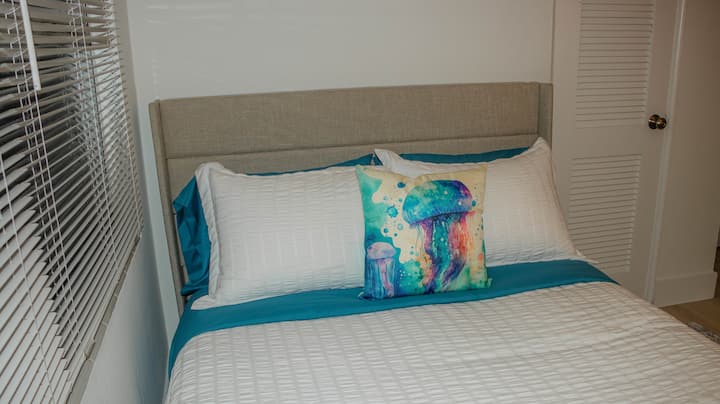 This cozy bedroom includes a full bed and a single bed, ideal for families or small groups.