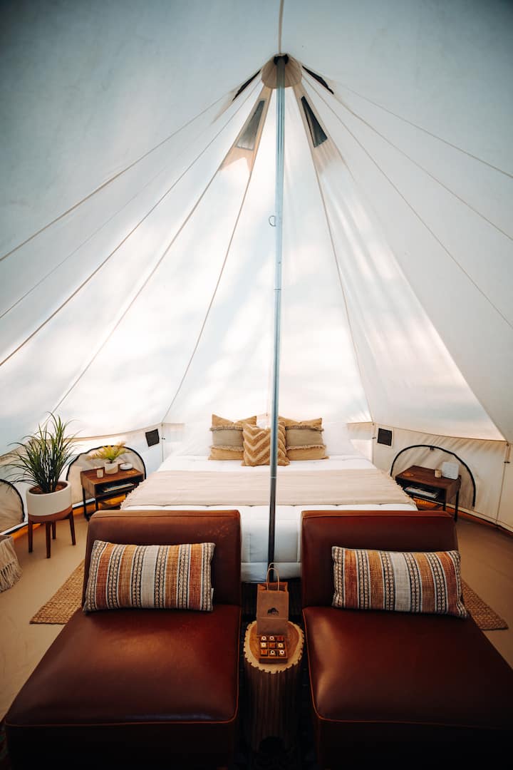 A lavishly cozy king bed for an elevated glamping retreat.