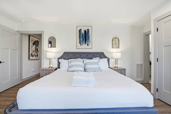 Private downstairs king master suite with ensuite bath, garage entrance, Keurig coffee station, and private deck access.
