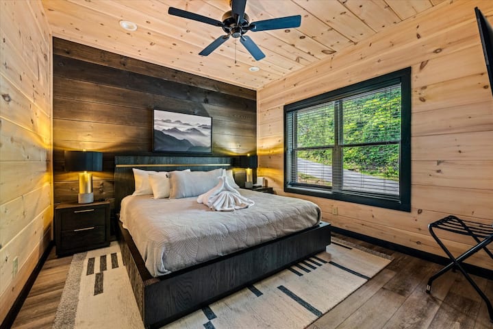 Esta acogedora suite tamaño king combina la comodidad moderna con el carácter rústico de una cabaña para una escapada perfecta.