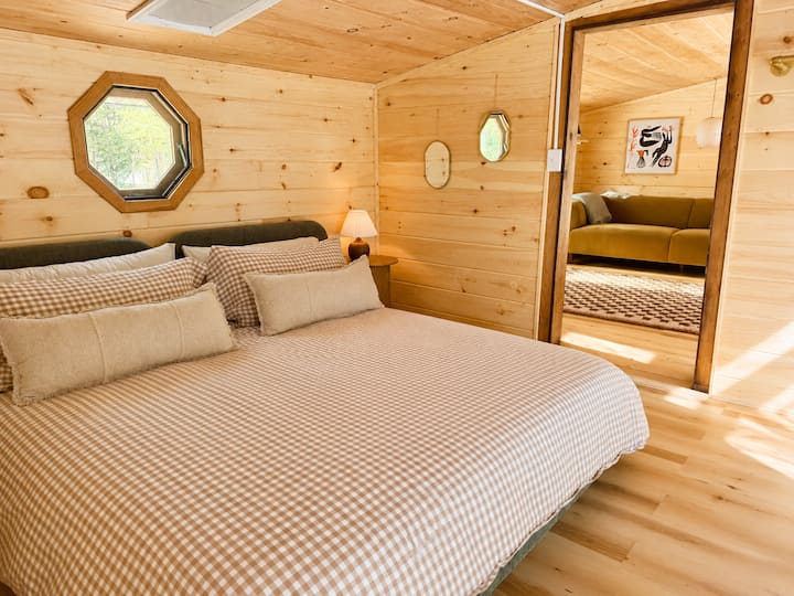A calm, light-filled bedroom designed for rest. HUGE king bed and best linens.