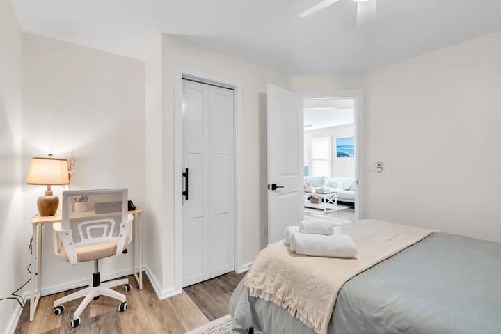 Bedroom two with a double bed and a dedicated desk with an office chair