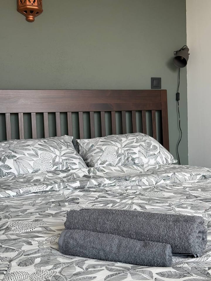 Comfortable double bedroom with quality bedding, air conditioning and blackout curtains for a restful sleep.