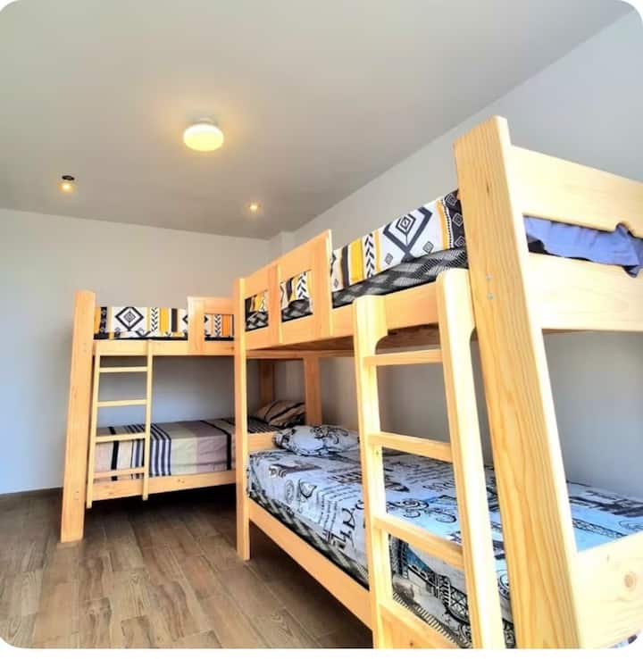 Two double bunk beds with shared bathroom