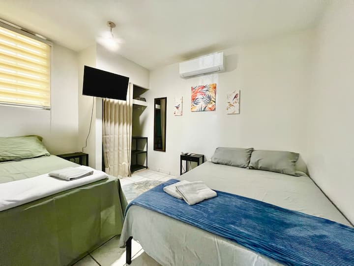 Bedroom 2: 1 full bed and 1 twin bed, ensuring space for the whole family. It also has A/C, a ceiling fan, a Smart TV, and a closet. Nightstands with electrical outlets for added convenience for phones and electronic devices.