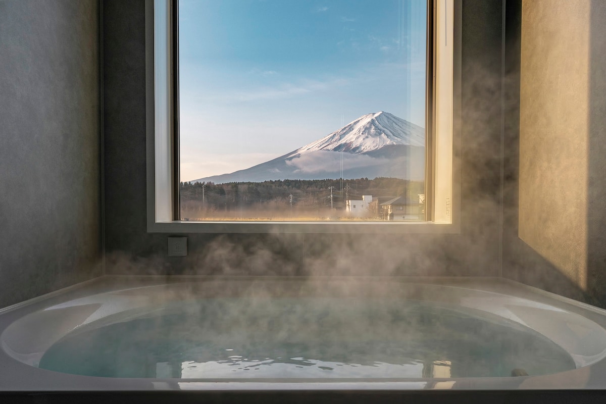 Private bath at a Kawaguchiko villa with Mt Fuji visible through the window