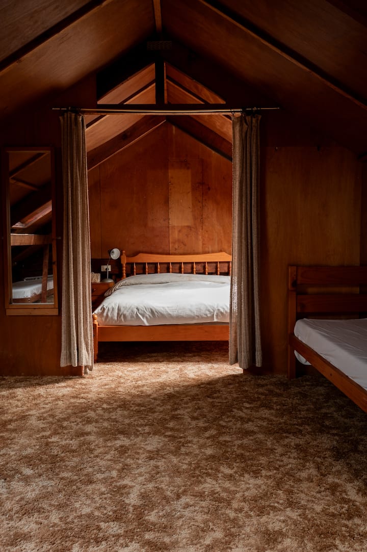 Upstairs attic bedroom. Also has some single beds up here please note this room is not insulated. Can be hot in the summer and cold in winter.