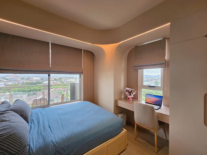 Jr Masters Bedroom has a huge window with view outside. It has a dedicated workstation with fast internet at 400 Mbps.

Comfortable bedroom setup for couples, families, or friends traveling together.

Disclaimer: Laptop is not included.