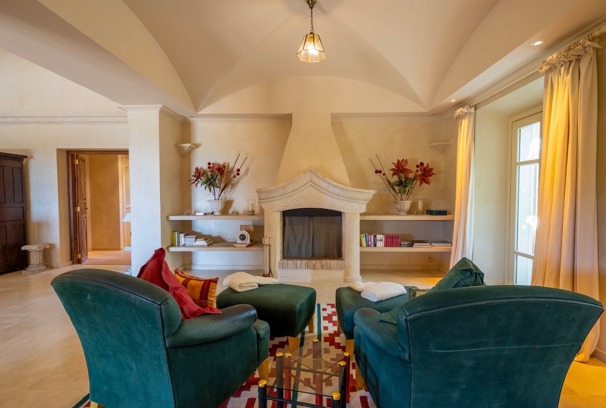 Living room of The Mallorcan House, with a stone fireplace
