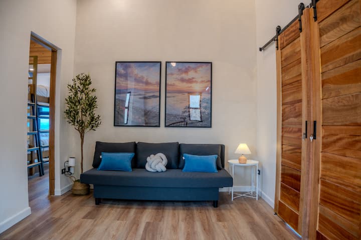 A cozy hallway lounge with a pull-out sofa bed — a nice extra crash spot when the group grows.