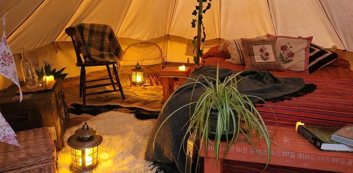 The bell tent has a proper double bed and is equipped with blankets and lanterns