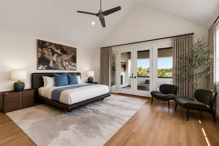 King bed #4 with private balcony access, mini fridge, sink area, and spacious seating area.