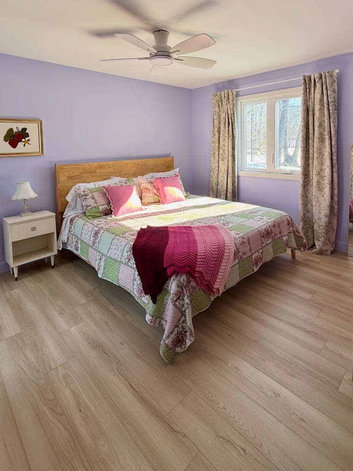 Main level King Bedroom with a sliding door walkout and lake views.